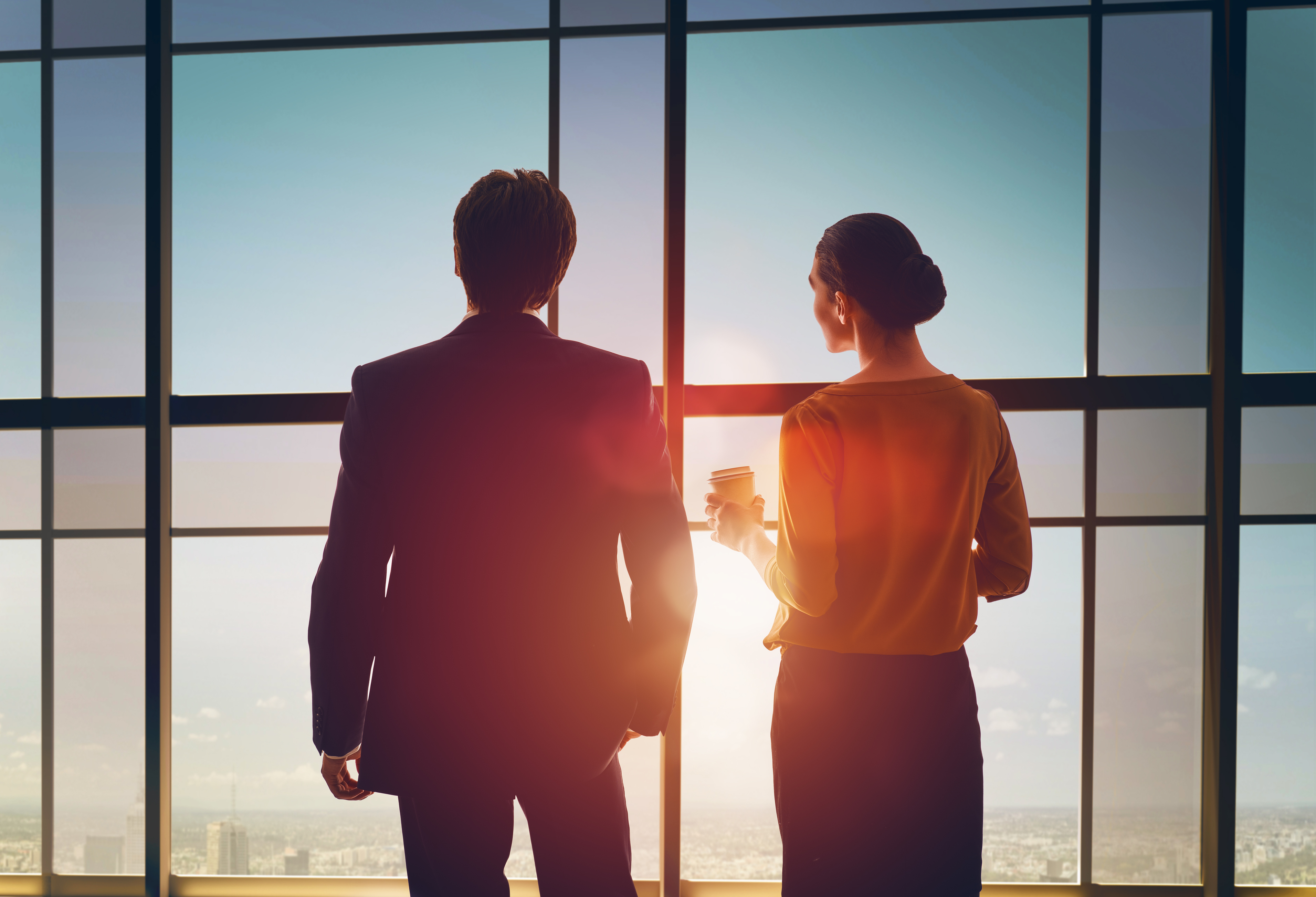 Business people looking out the window at the horizon